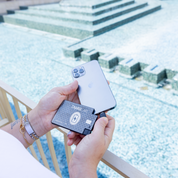 Hand inserting a ChargeCard charger into a smartphone’s USB-C port at resort