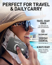 Woman holding AquaVault ChargeCard near her face, ready for travel.